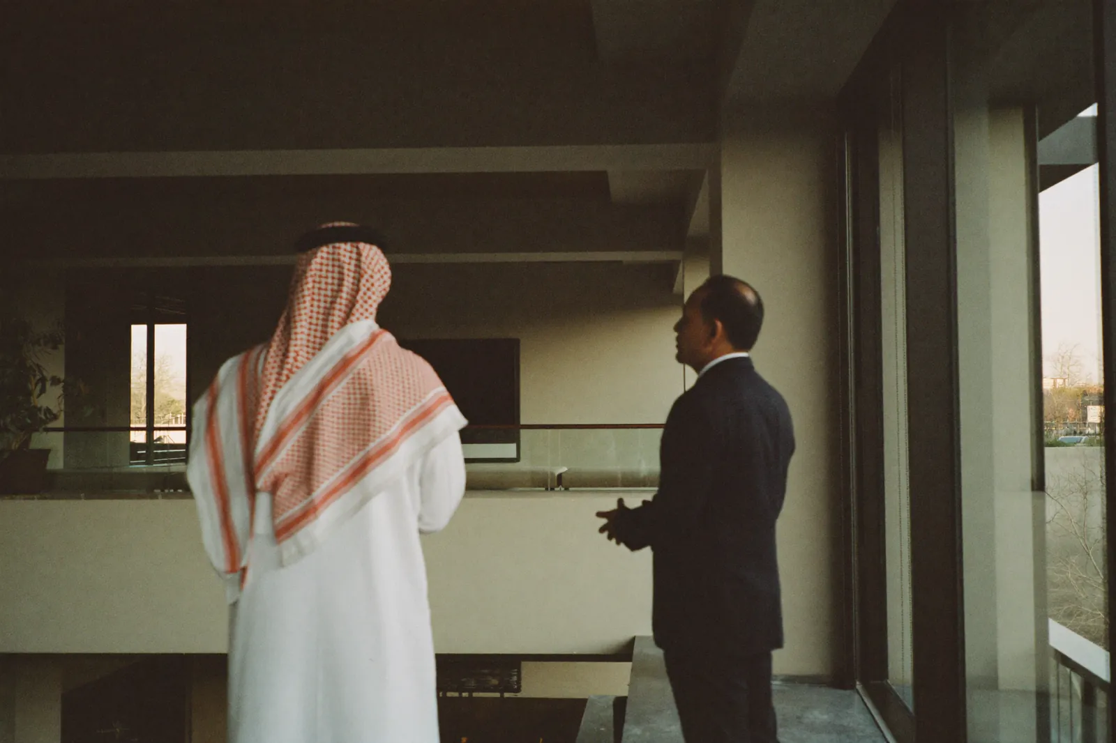 Senior figures in conversation in a contemporary architectural setting